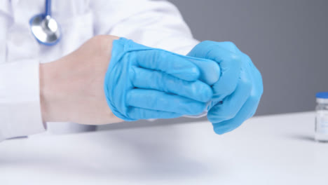 Close-Up-Shot-of-Medical-Professional-Removing-Latex-Gloves