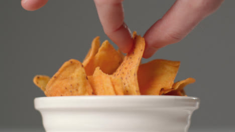 Sliding-Shot-Approaching-Bowl-of-Nachos-as-Hand-Takes-One-