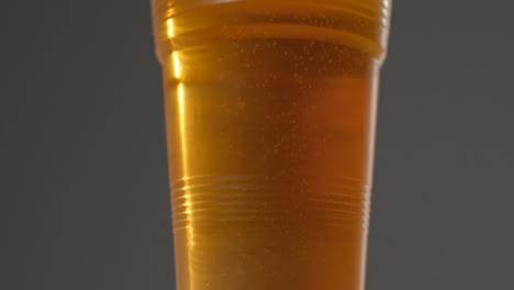 Sliding-Shot-Approaching-a-Plastic-Cup-of-Beer