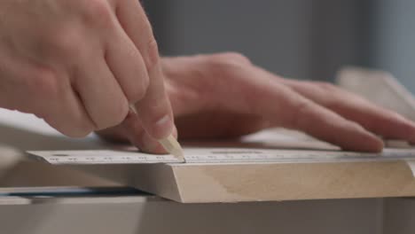Close-Up-Shot-of-Hand-Using-Pencil-to-Mark-Cutting-Lines-On-Skirting-Board