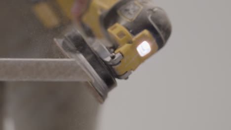 Extreme-Close-Up-Shot-of-Sander-Being-Used-On-Skirting-Board