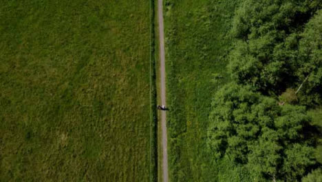 Drone-Shot-Tracking-Couple-On-Rural-Footpath-and-Panning-Up-to-Rural-Manor-House
