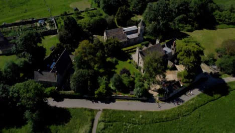 Drone-Shot-Tracking-Along-Footpath-and-Panning-Up-to-Rural-Manor-House