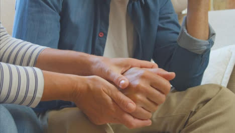 Close-Up-Shot-of-Middle-Aged-Woman-Holding-Stressed-Husbands-Hand