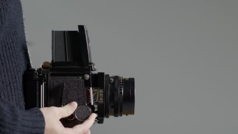 Side-Profile-Shot-of-Persons-Hands-Holding-Mamiya-RB67-and-Taking-Photo