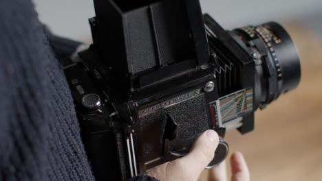 High-Angle-Shot-of-Persons-Hands-Holding-Mamiya-RB67-and-Taking-Photo