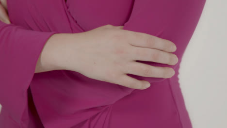 Close-Up-Shot-of-Model's-Hands-as-She-Poses-in-Front-of-White-Backdrop