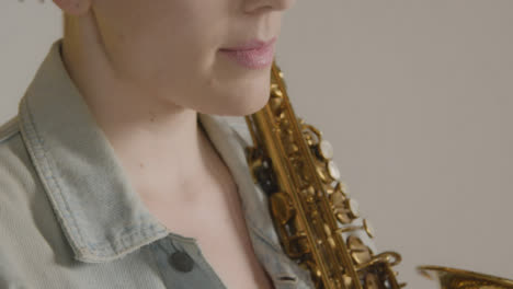 Close-Up-Shot-of-Model-Posing-with-Saxophone