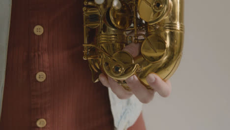 Close-Up-Shot-of-Model's-Hands-Holding-Saxophone