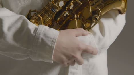 Close-Up-Shot-of-Model's-Hands-Holding-Alto-Saxophone