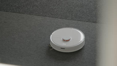 High-Angle-Shot-of-a-Robotic-Vacuum-Cleaner-Cleaning-a-Carpet