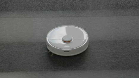 High-Angle-Shot-of-a-Robotic-Vacuum-Cleaner-Cleaning-Carpet