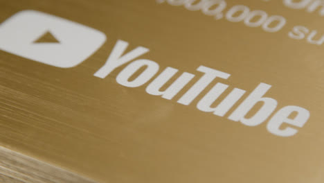 Extreme-Close-Up-Shot-of-YouTube-1,000,000-Subscriber-Milestone-Plaque-Rotating-