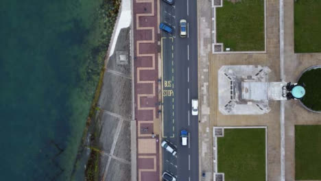 Drone-Shot-Looking-Down-on-Coastal-Road-and-Footpath
