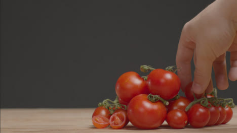 Medium-Shot-of-Pile-of-Tomatoes-as-Hand-Takes-One-Away