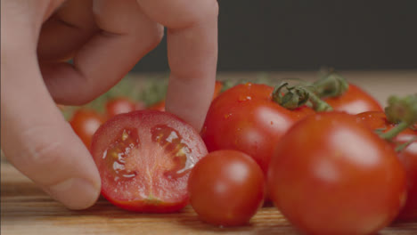 Close-Up-Shot-of-Taking-Half-a-Tomato-Out-of-Frame