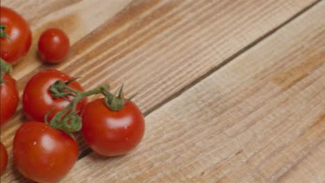 Close-Up-Shot-Panning-Over-Tomatoes-On-a-Rustic-Wooden-Table-