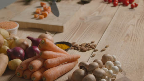 Tracking-Shot-Passing-Over-Rustic-Wooden-Table-with-Vegetables-On-It-01