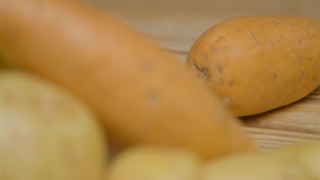 Pull-Focus-Shot-of-Potatoes-On-Rustic-Wood-Table