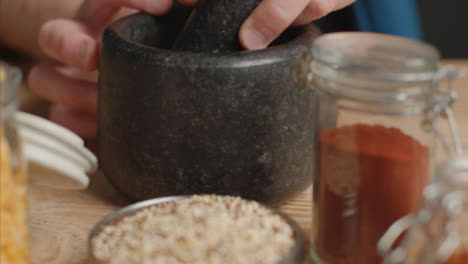 Tracking-In-Shot-of-Spices-to-Mortar-and-Pestle-on-Table