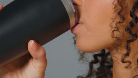 Close-Up-Shot-of-Young-Adult-Womans-Mouth-Drinking-from-Flask-01