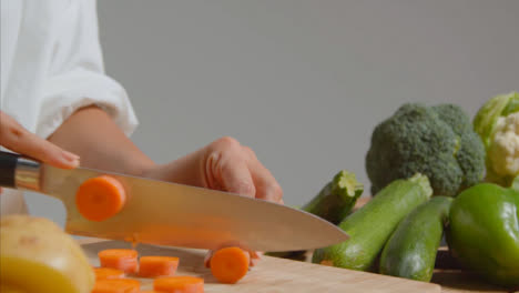 Tracking-Shot-of-Young-Adult-Woman-Slicing-Carrot