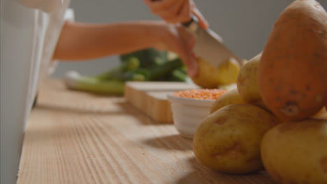 Tracking-Shot-of-Young-Adult-Woman-Slicing-Potato-04