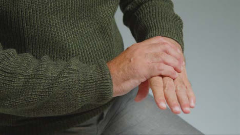 Close-Up-Shot-of-Senior-Man-Experiencing-Pain-In-His-Hand