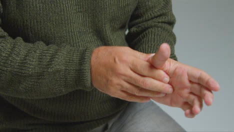 Close-Up-Shot-of-a-Senior-Man-Experiencing-Pain-In-His-Hand
