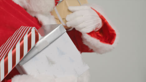 Close-Up-Shot-of-Santa-Holding-Presents-and-Gifts