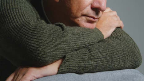 Close-Up-Shot-of-Senior-Man-Leaning-On-His-Arms