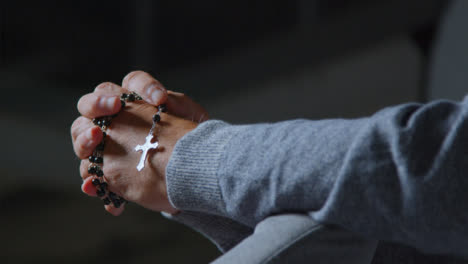 Pull-Focus-Shot-of-a-Senior-Mans-Hands-Holding-Some-Rosary-Beads