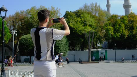 Medium-Shot-of-Young-Man-Taking-Photos-in-Sultanahmet-Square