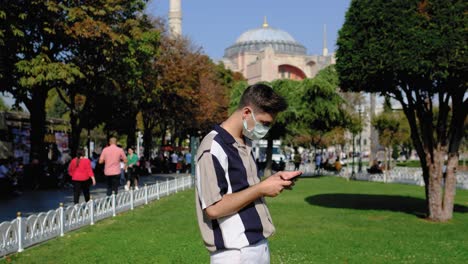 Wide-Shot-of-Young-Man-Taking-Photos-with-Mobile-Phone-Outside-Hagia-Sophia