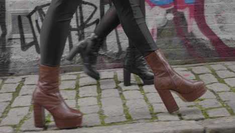 Tracking-Close-Up-of-Womens-Boots-Walking-on-Street