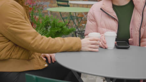 Tracking-Shot-of-Woman-Joining-Friend-for-Coffee