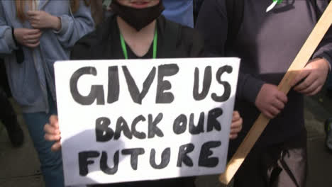 Boy-Activist-Holding-Signs-atCOP26-Climate-Change-Protest