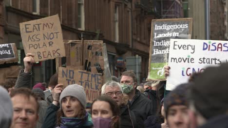Handheld-Shot-of-Signs-Being-Held-Up-During-COP26-Climate-Change-Protests-In-Glasgow