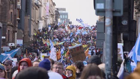 Handheld-Shot-of-Crowd-of-Global-Warming-Protestors-Marching-Through-Streets-of-Glasgow