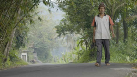 Low-Angle-Shot-of-Man-Walking-Through-Bali