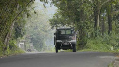 Low-Angle-Shot-of-Vehicle-Driving-Through-Bali