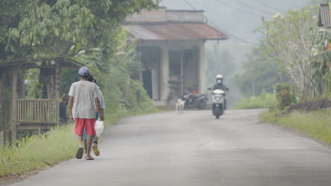 Long-Shot-of-People-Walking-and-Driving-Through-Bali