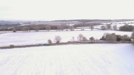 Drone-Shot-Flying-Over-Snow-Covered-Cotswold-Field