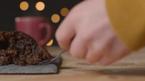 Close-Up-Shot-of-Fork-Picking-Piece-of-Christmas-Pudding