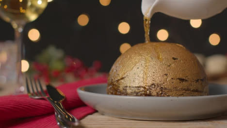 Close-Up-Shot-of-Alcohol-Being-Poured-On-Gold-Leaf-Christmas-Pudding