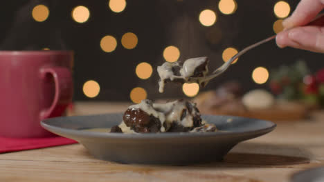 Primer-Plano-De-La-Mano-Con-Un-Tenedor-Para-Tomar-Un-Trozo-De-Pastel-De-Navidad-De-Chocolate