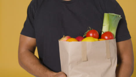 Close-Up-Shot-of-Man-Holding-Bag-of-Fruit-and-Vegetables
