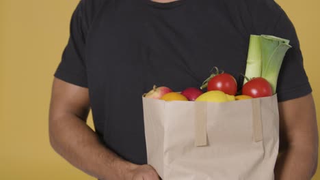 Close-Up-Shot-of-Man-Holding-Bag-of-Fruit-and-Vegetables