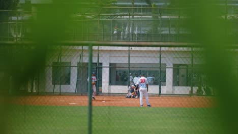 Tracking-Shot-of-Young-Men-Playing-Softball-In-Jakarta-