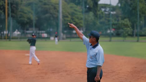 Tracking-Shot-of-a-Softball-Umpire-Officiating-a-Match
